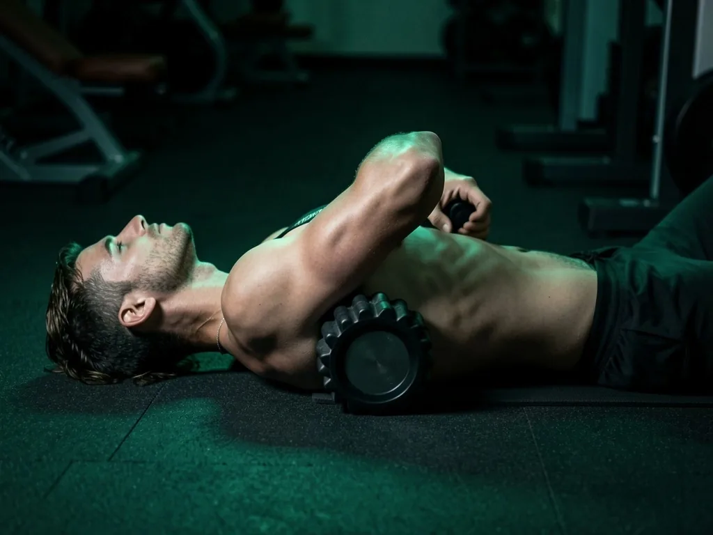 Person using a muscle massage roller on their lat muscles